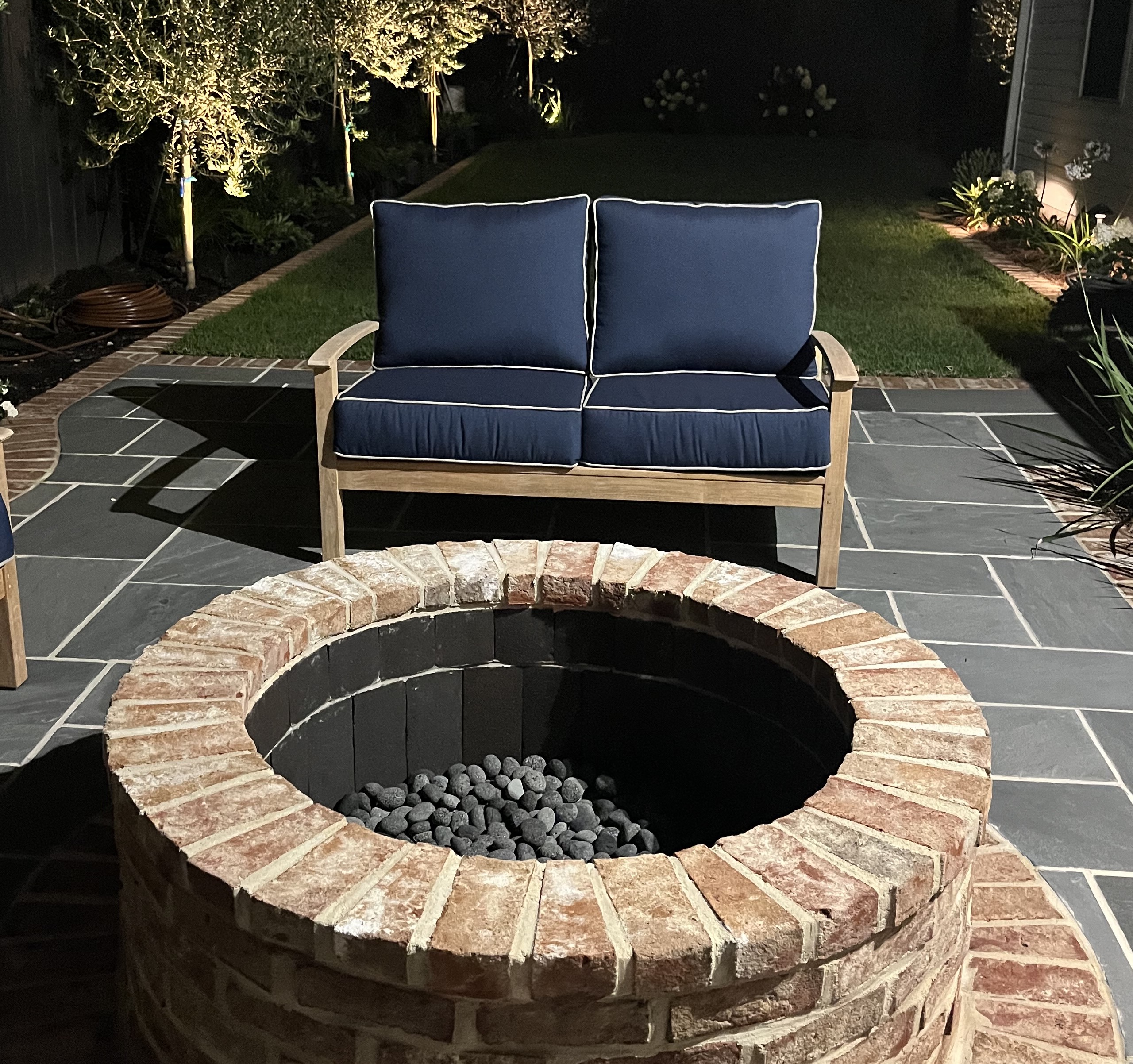 A Dreamer and Her Craftsman bluestone patio, firepit, landscaping, and lighting install